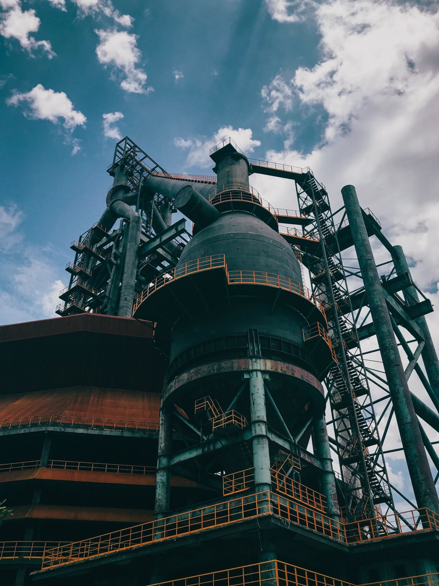 A dark industrial water-treatment plant, pipework and tanks lit low — the environment Ecoklin filters are built for.